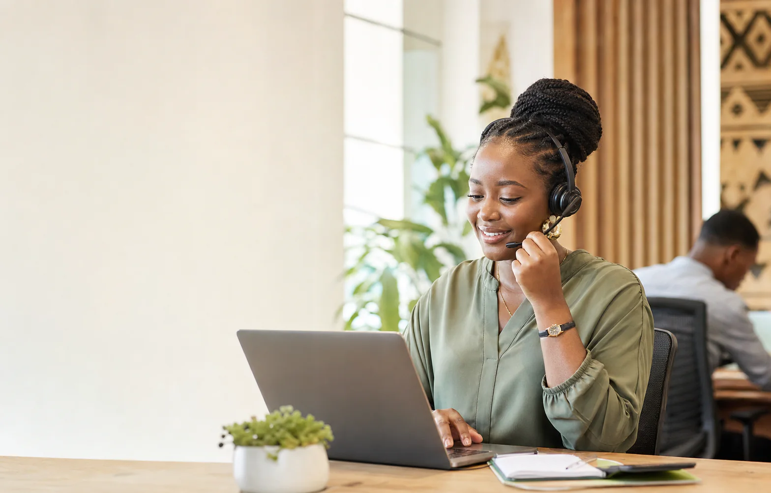 A Ghanaian SendIt support specialist helping a customer